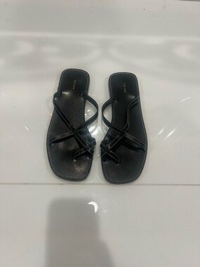The Row link  Black Leather Strappy Toe-Ring Sandals